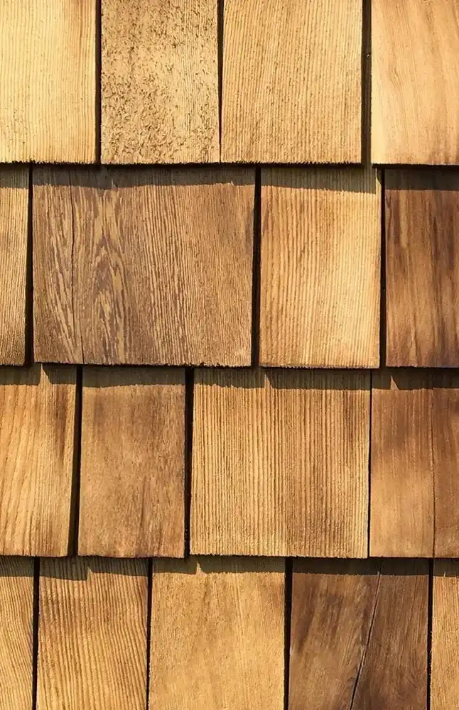 Close-up of wood shake siding, showcasing the intricate pattern and texture of the natural material.